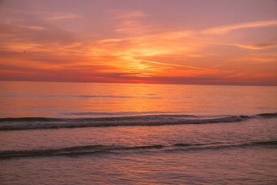 Scenic view of sea against orange sky
