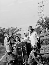 Young couple standing against clear sky