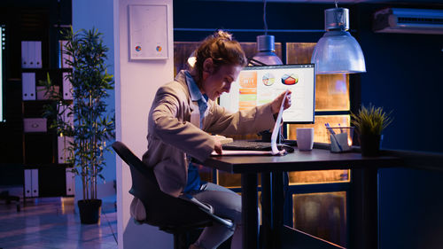 Young woman using digital tablet in office