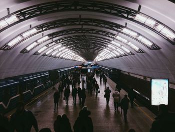 People walking in illuminated city