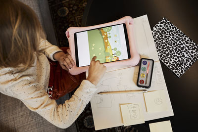 Girl at occupational therapy session using digital tablet