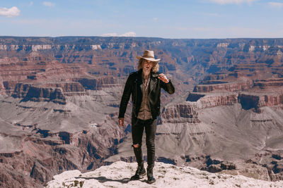 Man standing on rock against mountains