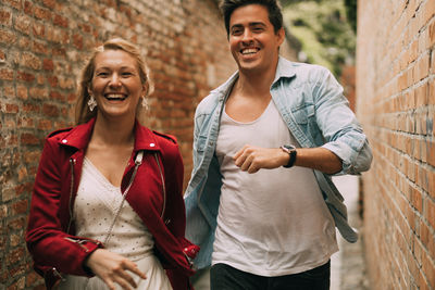 Smiling couple walking in alley