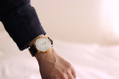 Cropped hand of women wearing wristwatch