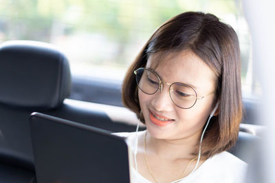 Portrait of young woman using mobile phone