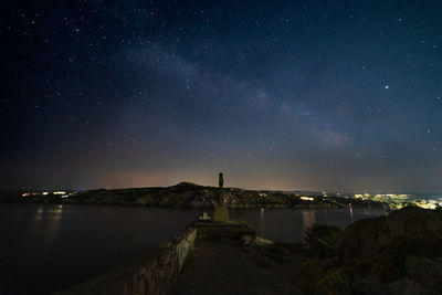 Scenic view of sea against sky at night with stars and milky way