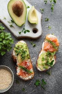 Sandwiches with salted salmon, avocado and microgreens. healthy food.