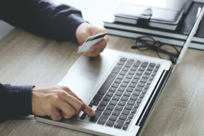 High angle view of man using laptop on table