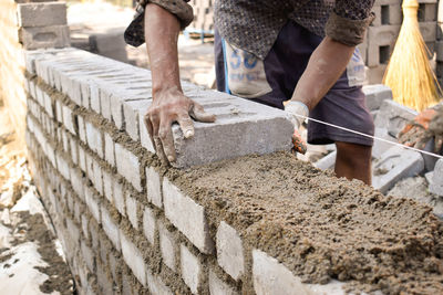 Low angle view of man working on concrete
