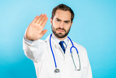 Man standing against blue background