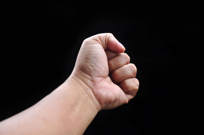 Close-up of hand against black background