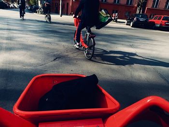 Low section of people riding bicycle on road