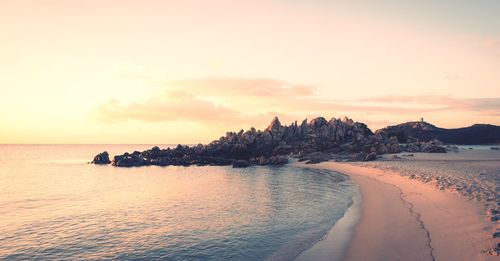 Scenic view of beach against sky during sunset