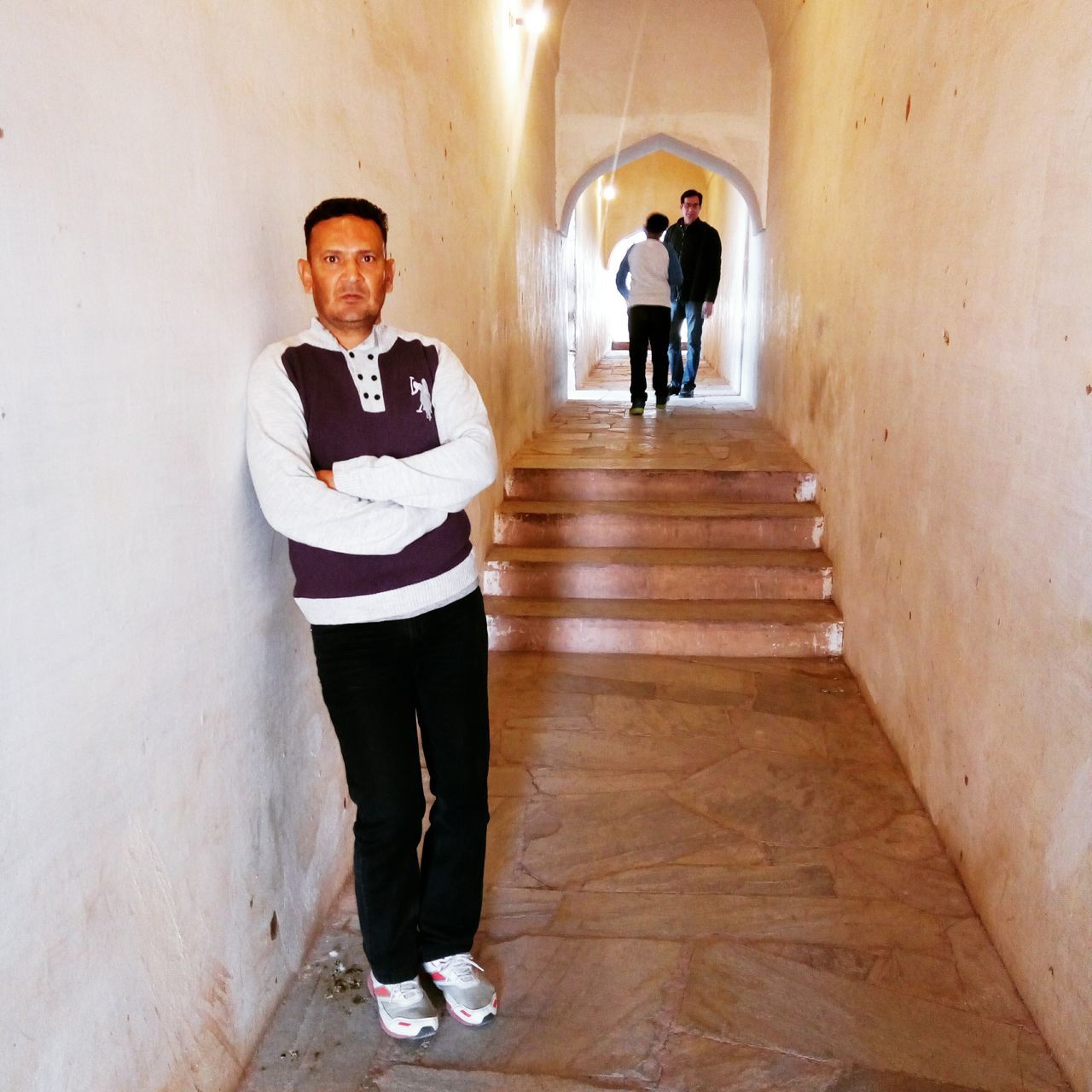 FULL LENGTH OF A YOUNG COUPLE IN CORRIDOR