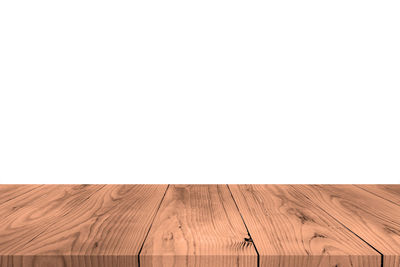 Empty wooden floor against clear sky