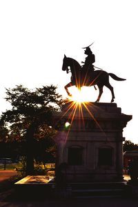Low angle view of statue against sky during sunset