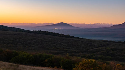 Scenic view of landscape against sky during sunset