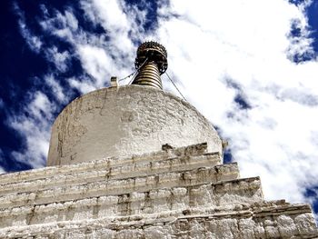 Low angle view of tower against cloudy sky