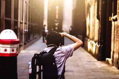 Young woman photographing in city