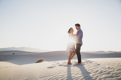 Side view of smiling couple at desert
