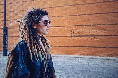 Side view of woman walking in the street