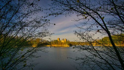 Scenic view of river against cloudy sky