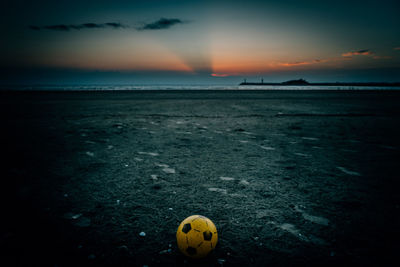 Scenic view of beach against sky during sunset