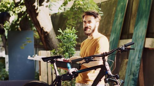 Portrait of young man riding bicycle