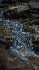 Close-up of water flowing through rocks