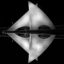 Close-up of illuminated water over black background