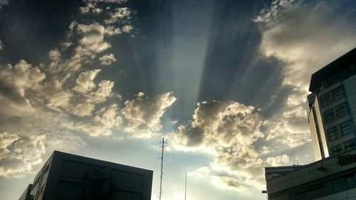 Low angle view of building against cloudy sky