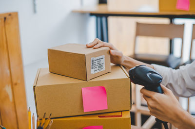 Midsection of woman holding box