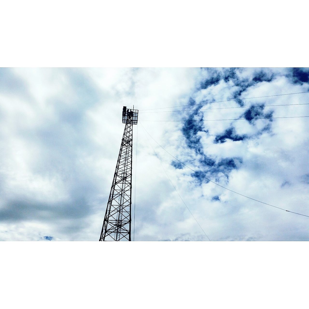 LOW ANGLE VIEW OF ELECTRICITY PYLON AGAINST CLOUDY SKY