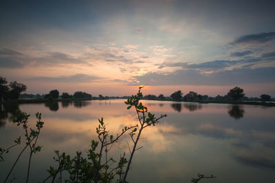 Scenic view of lake against sky during sunset