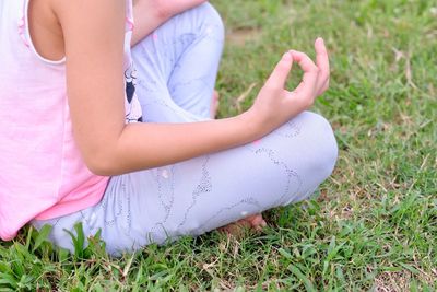 Low section of girl playing on field