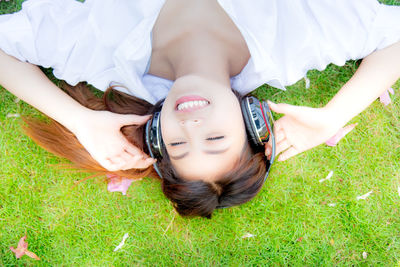 High angle portrait of woman relaxing on field