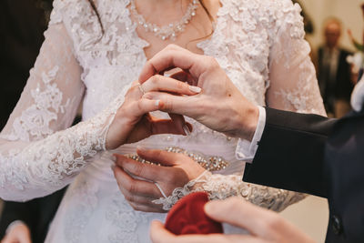 Midsection of couple holding hands