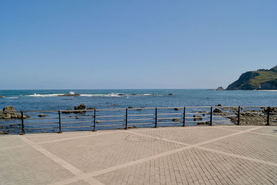 Scenic view of sea against clear blue sky