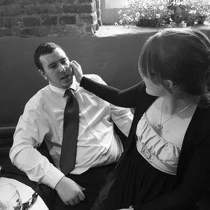 Man looking at woman sitting on lap in restaurant