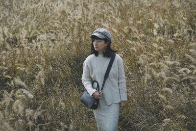 Full length of young man standing on field