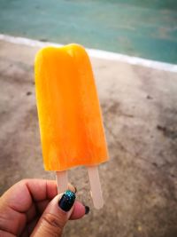 Close-up of hand holding ice cream