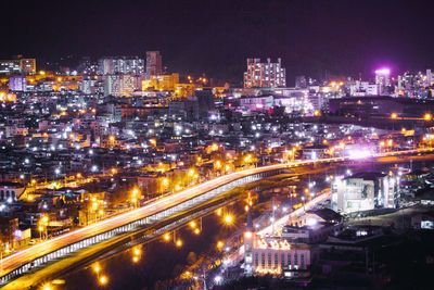 High angle view of illuminated city buildings at night