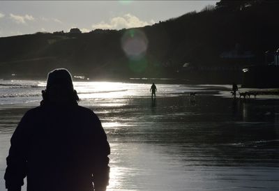 Silhouette of tourists on beach