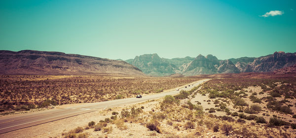 Empty road along barren landscape