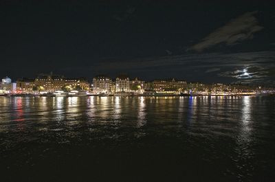 Illuminated city at waterfront