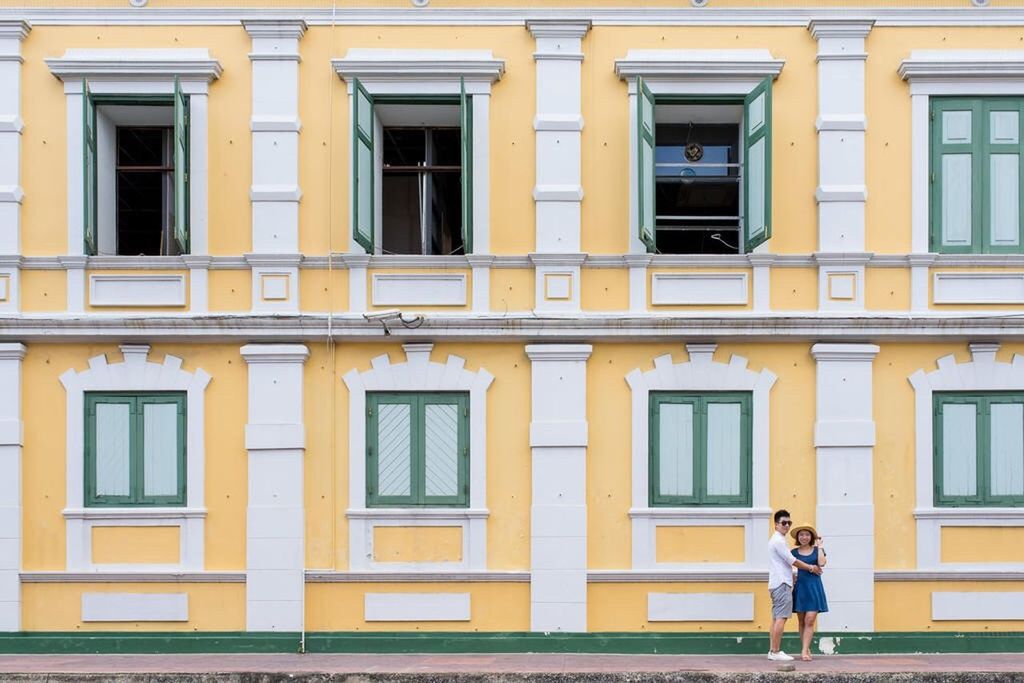 building exterior, architecture, built structure, window, lifestyles, yellow, men, building, leisure activity, walking, person, residential building, residential structure, full length, facade, outdoors, city