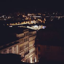 High angle view of illuminated buildings in city at night