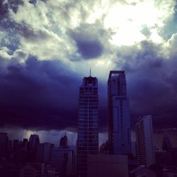 City skyline against cloudy sky