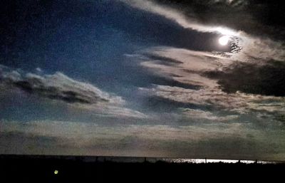 Scenic view of silhouette moon against sky at sunset