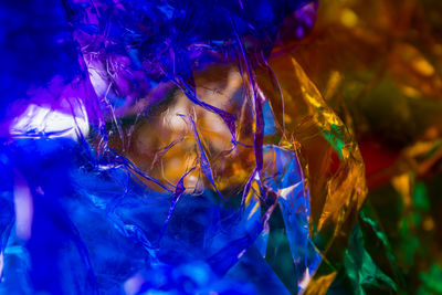 Close-up portrait of woman with colorful leaves
